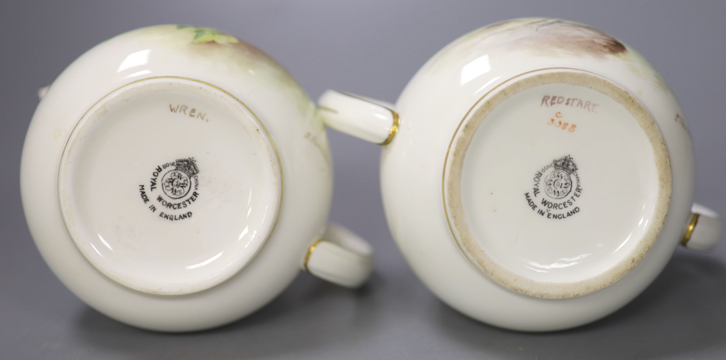 A Royal Worcester sugar bowl painted with a Redstart and cover and a cream jug painted with a Wren by E. Townsend, signed black mark